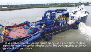The vessel Captain John Graham carries the Arulaq dredge plant. The blue piping represents most of the dredge works. The dredge pushes out 60,000 gallons of mud per minute.