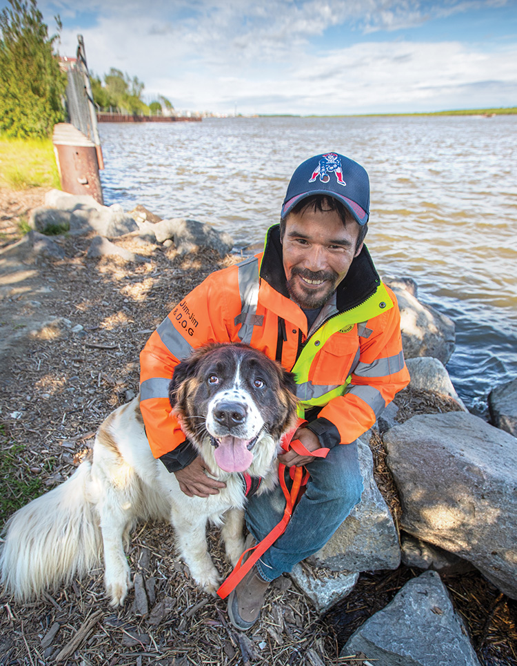 Jim Pete with Bethel Search and Rescue dog named D.O.G. Photo courtesy Greg Lincoln/The Delta Discovery.